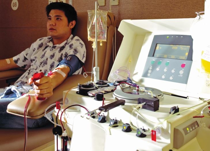 A patient donating stem cells connected to an apheresis machine. • Photo by Tareq Salahuddin